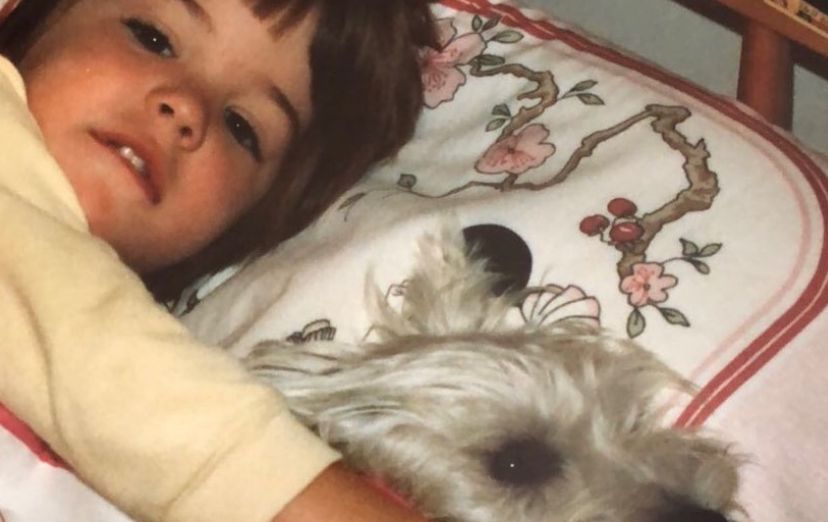 Young Gemma Atkinson in bed cuddling dog