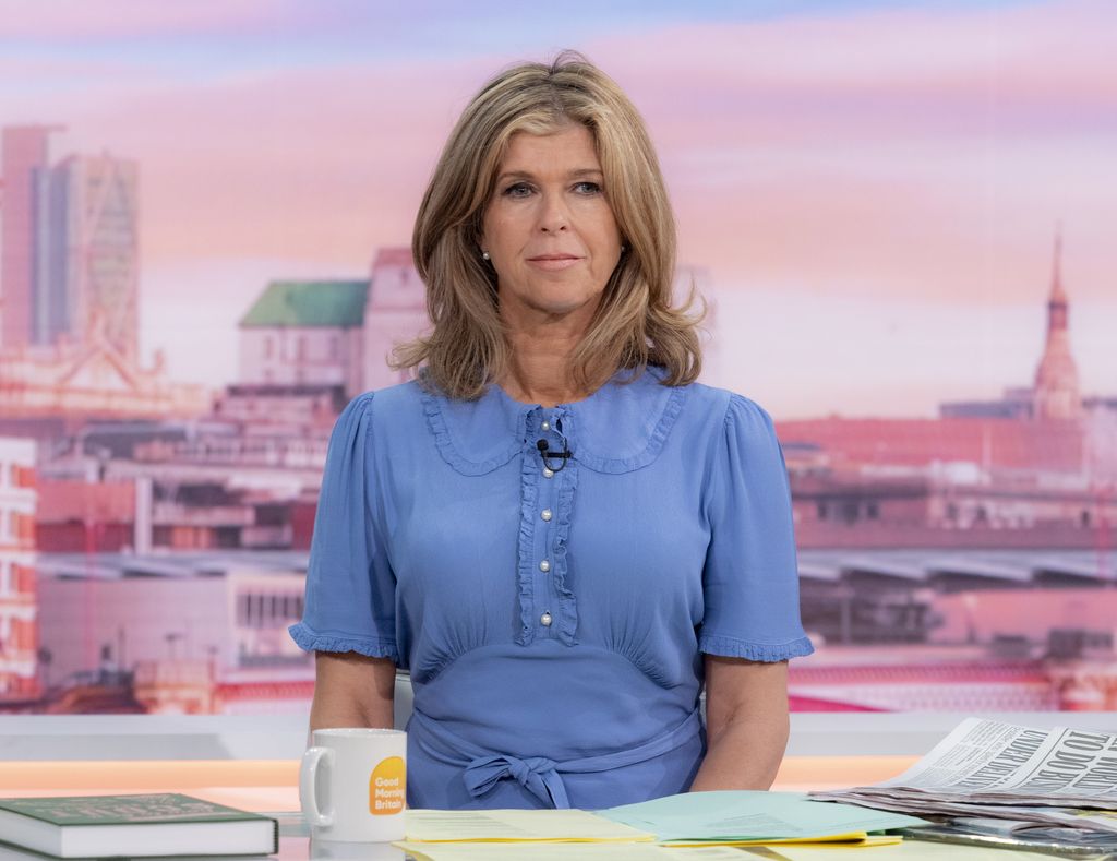 Kate Garraway looking serious in a blue dress whilst presenting GMB