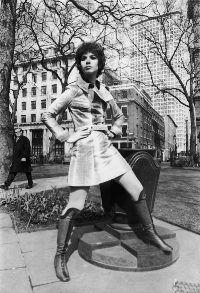 Linda posing outside with her hands on her hips