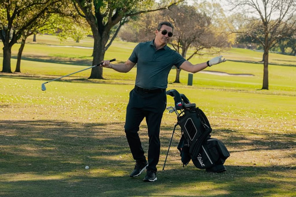 A man shrugs while playing golf