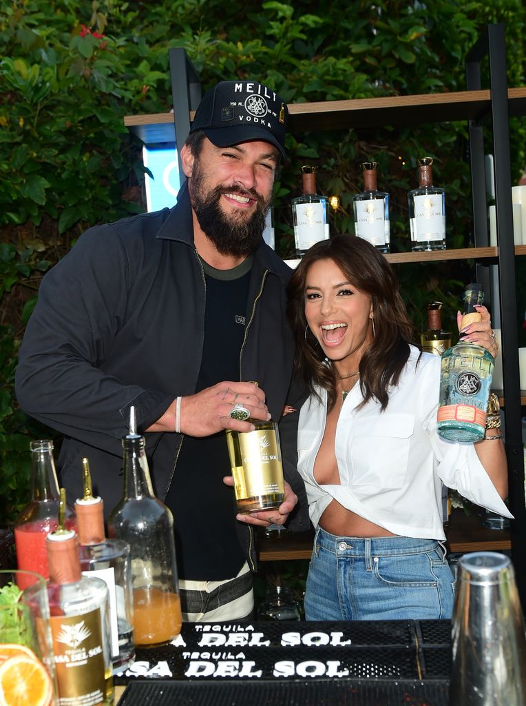 Eva Longoria serves up tequila in ab-baring jeans and fans are all