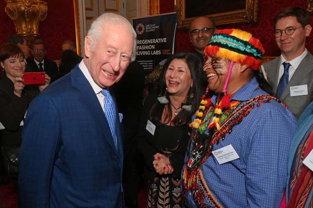 King Charles laughing with a group of people