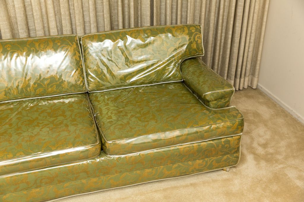 Antique sofa covered in plastic