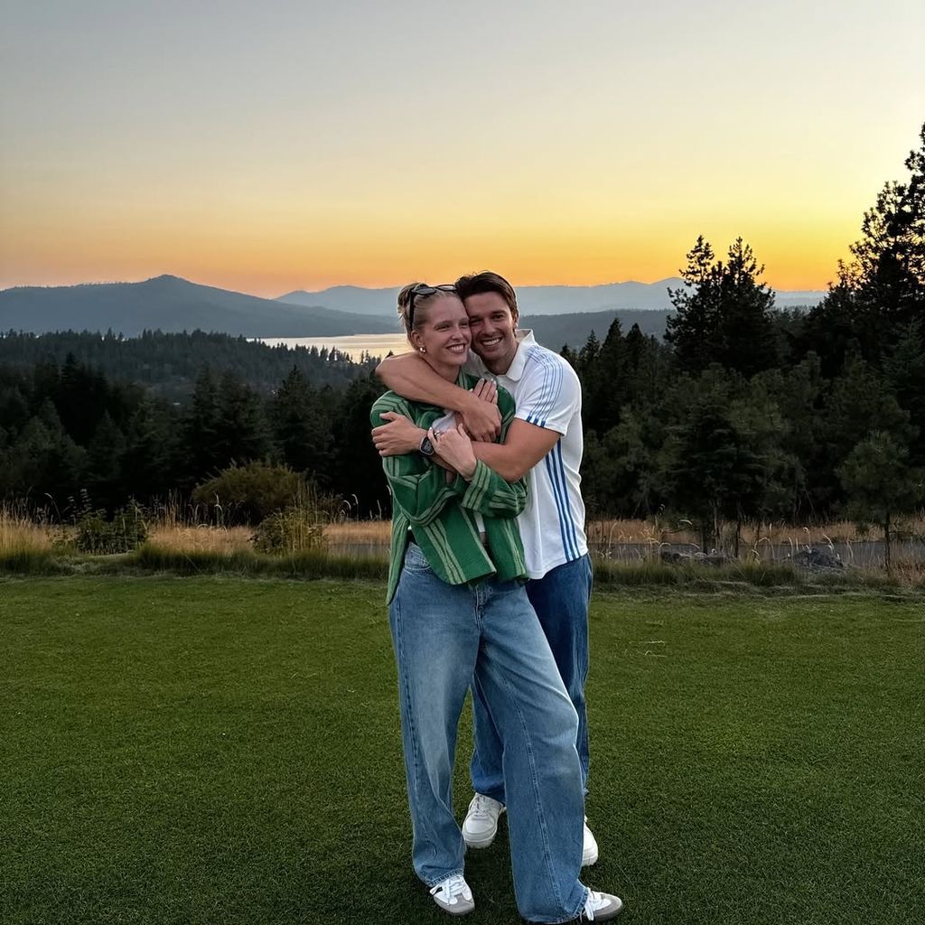 Patrick and Abby hugging in front of a sunset