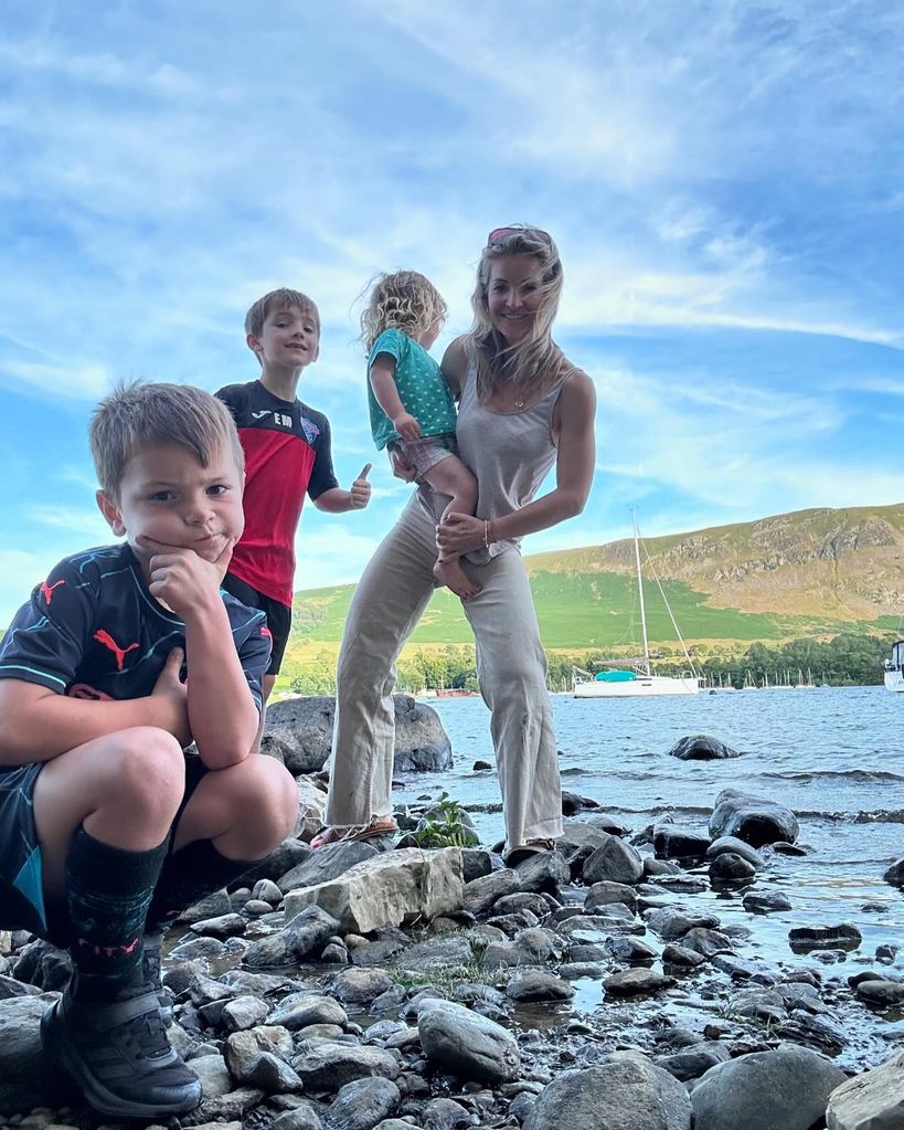 helen skelton posing next to lake with kids