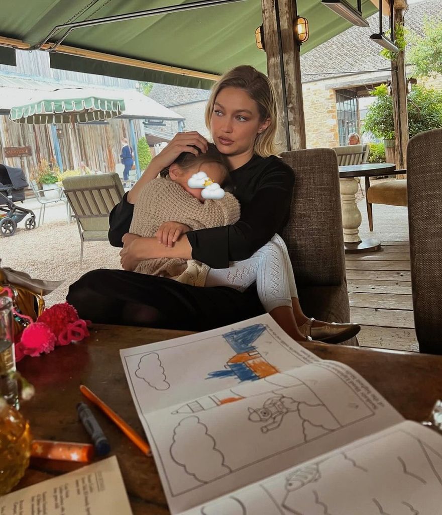 Gigi cradled her daugher during a rainy day at Soho Farmhouse