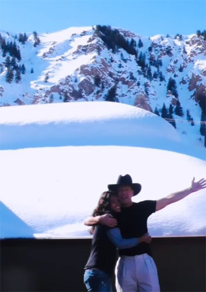 Bruce Willis and Emma Heming in front of a mountain