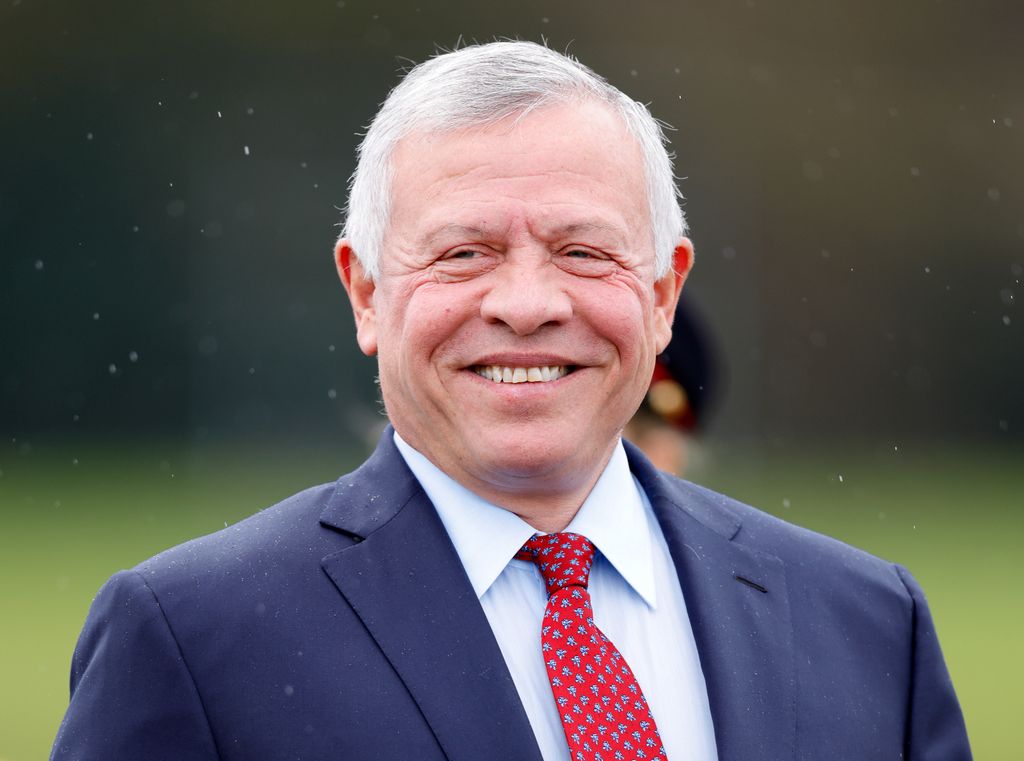 King Abdullah in a suit and red tie