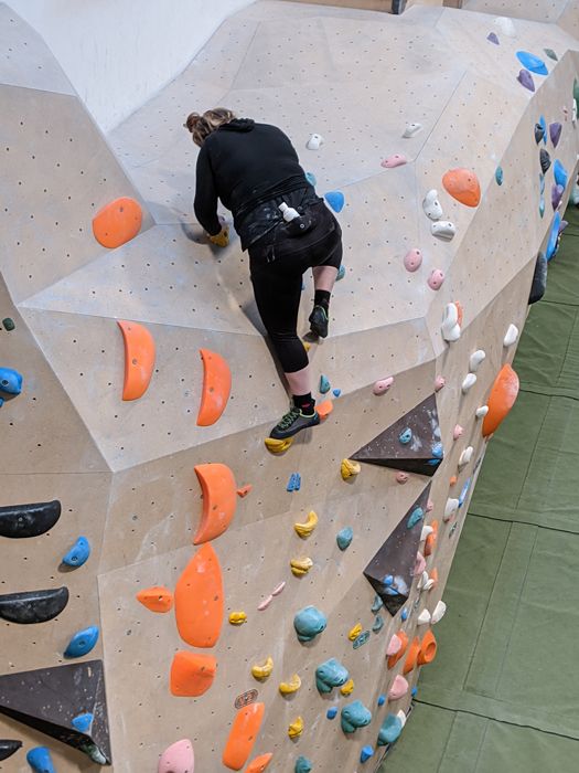 Young woman on a climbing wall