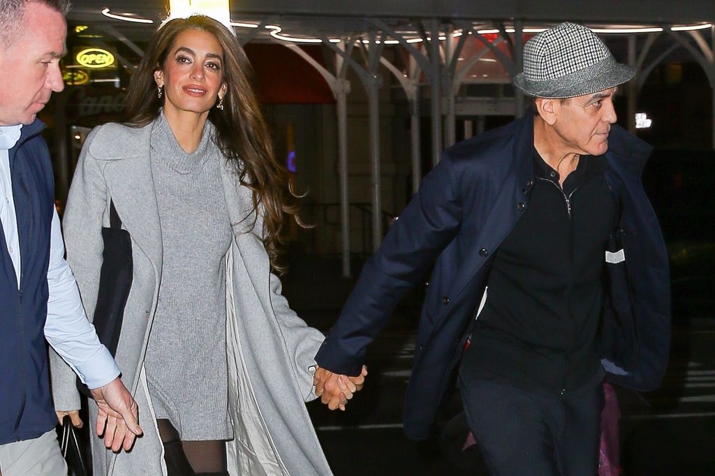 George Clooney and his wife Amal Clooney hold hands as they head out together in New York.