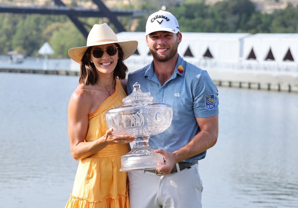 photo of sam burns holding walter haggen cup with wife caroline campbell