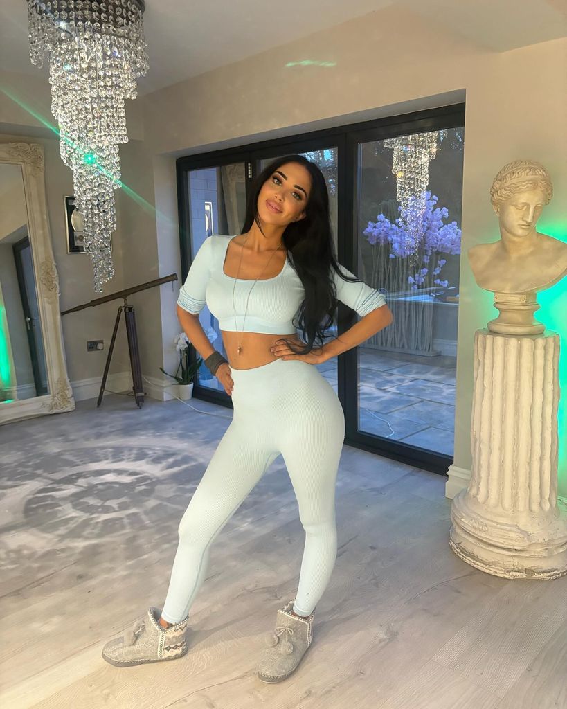 tulisa posing in sparsely decorated living room