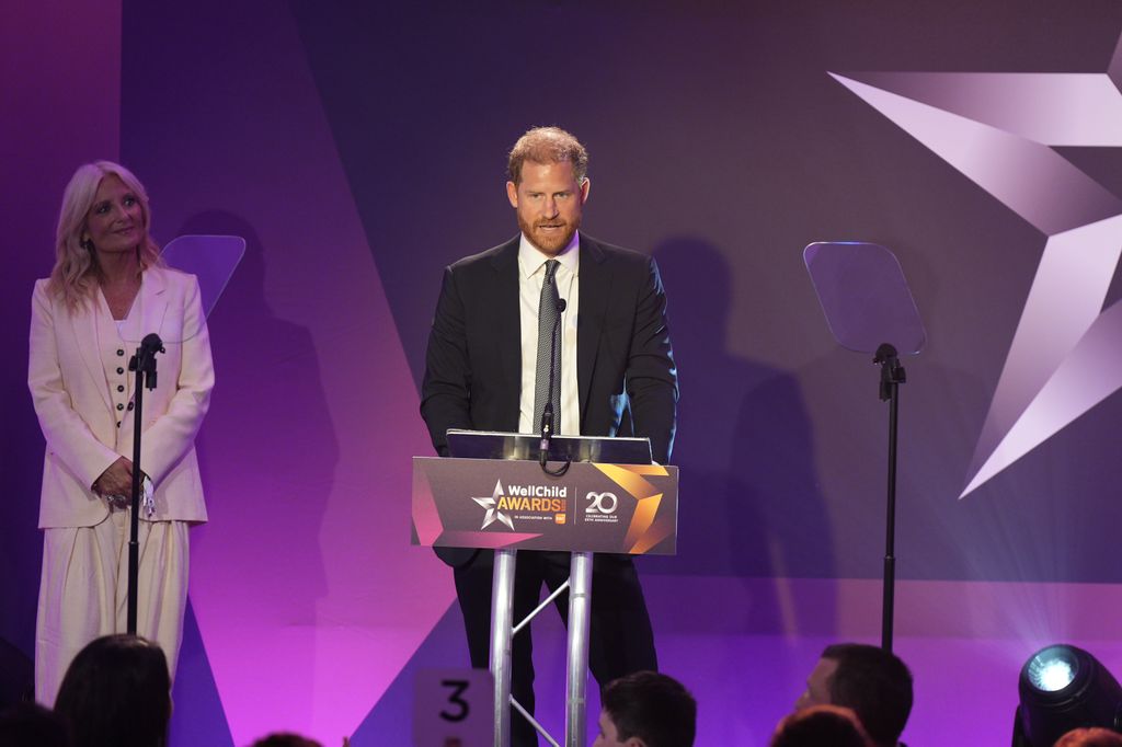 Harry delivering his speech as host Gaby Roslin looks on