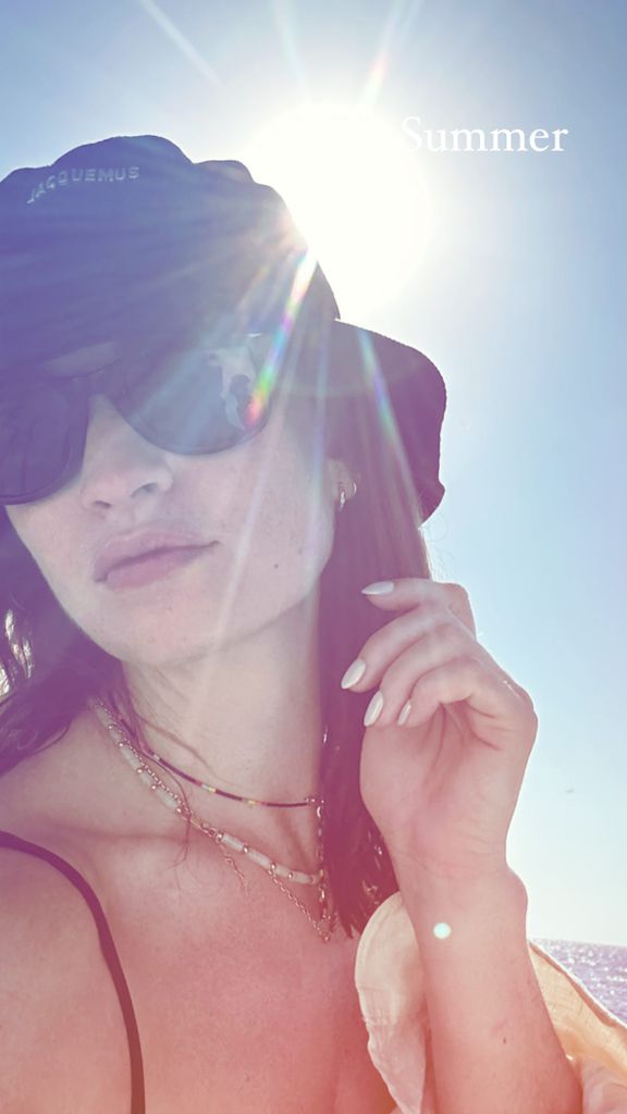 Lily James shared a photo of herself wearing the hat on holiday