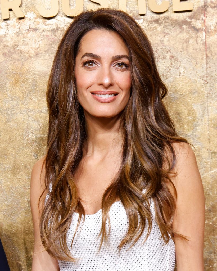 Amal Clooney wearing a white dress at the Clooney Foundation for Justice's 2023 Albie Awards