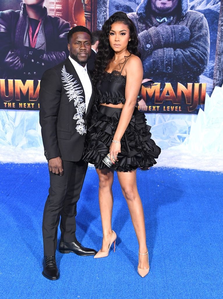 Kevin Hart and Eniko Parrish with their arms around eachother at the Premiere Of Sony Pictures' "Jumanji: The Next Level"