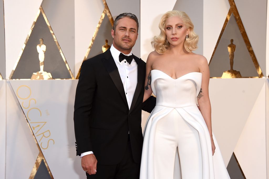 Lady Gaga (R) and actor Taylor Kinney attend the 88th Annual Academy Awards in 2016