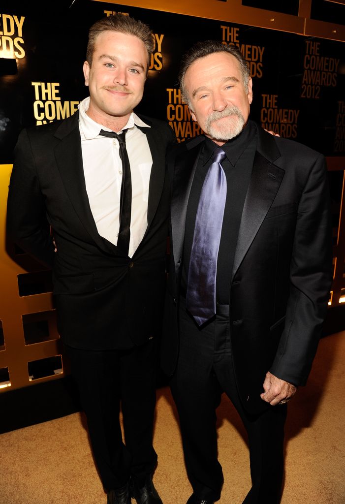 Robin poses with his son, Zachary Pym Williams, on red carpet in 2012