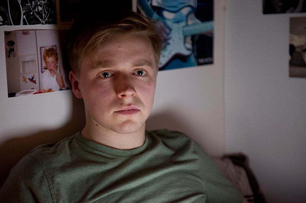 close-up teenage boy lying in bed