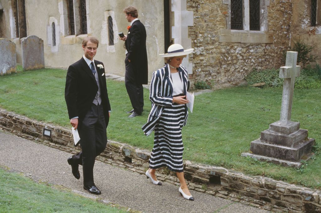 Princess Diana in a blue and white striped skirt suit with her brother-in-law Prince Edward