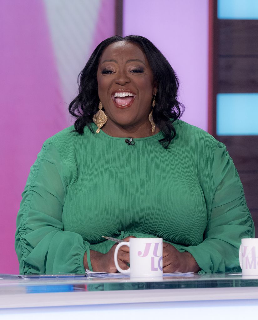 Judi Love smiling in a green top