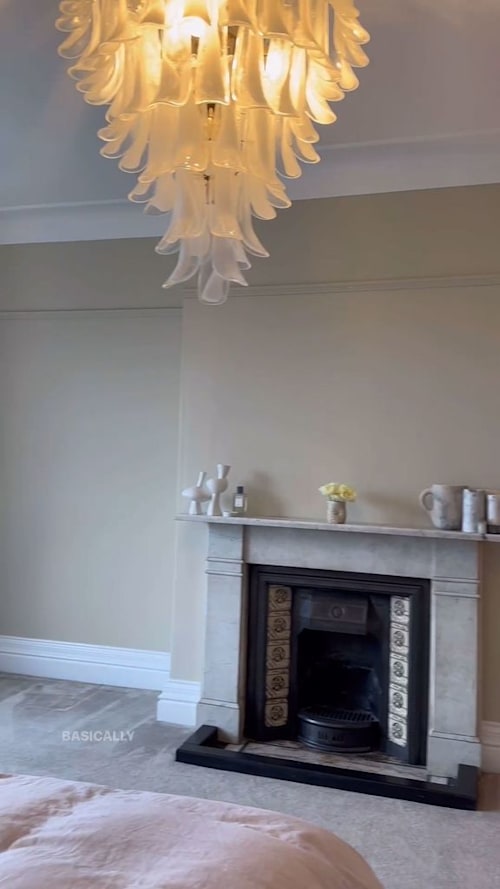 bedroom with glass chandelier and fireplace 