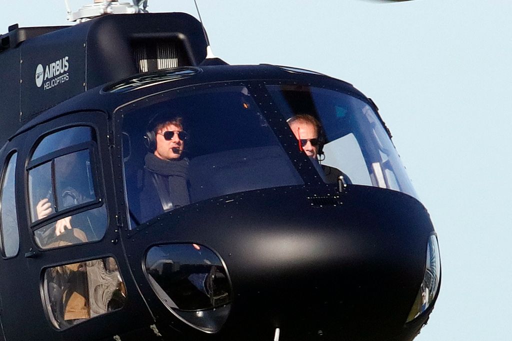 Tom Cruise flying in a black helicopter