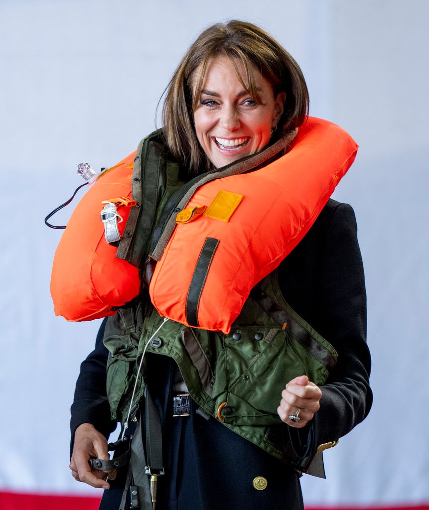 Kate Middleton laughs as she inflates a life vest