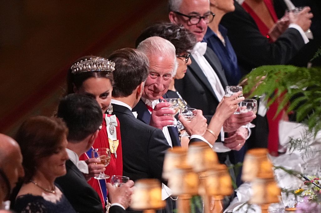President of France Emmanuel Macron clinks glasses with King Charles III during the State Banquet for President of France Emmanuel Macron and his wife Brigitte Macron, at Windsor Castle 