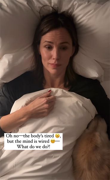 Jennifer Garner in bed with a dog