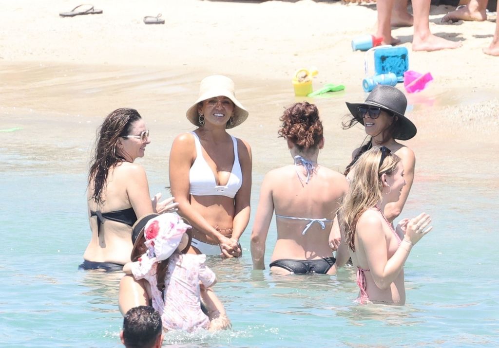 Luciana Barroso cools off in the water with friends 