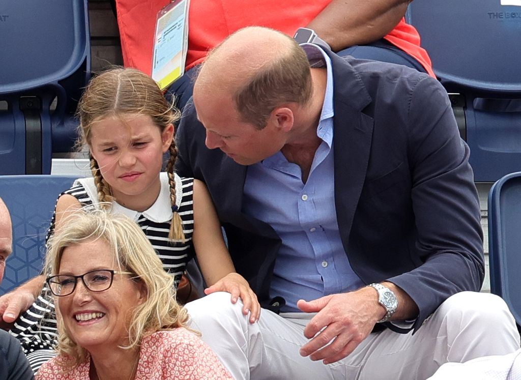 Prince William bent to Charlotte's level talking to her