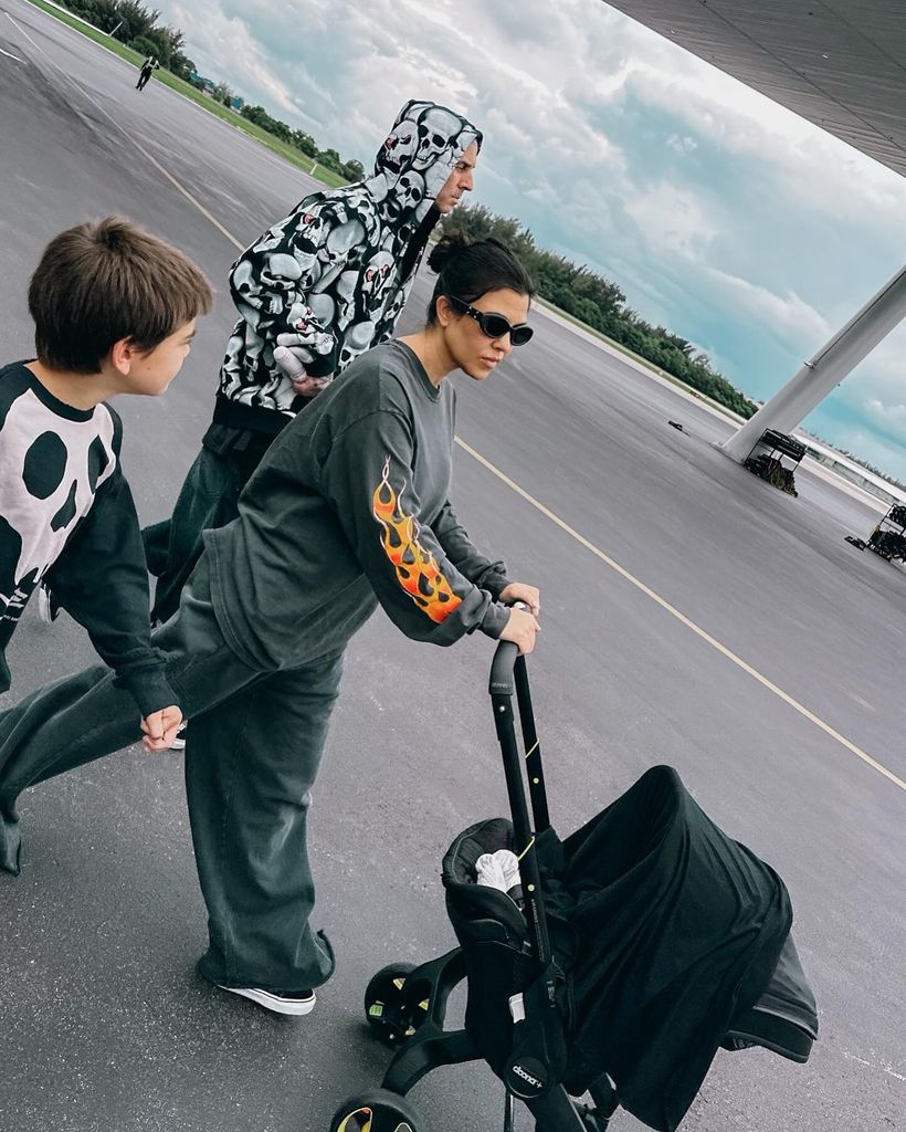 Kourtney Kardashian and Travis Barker with Rocky in the stroller