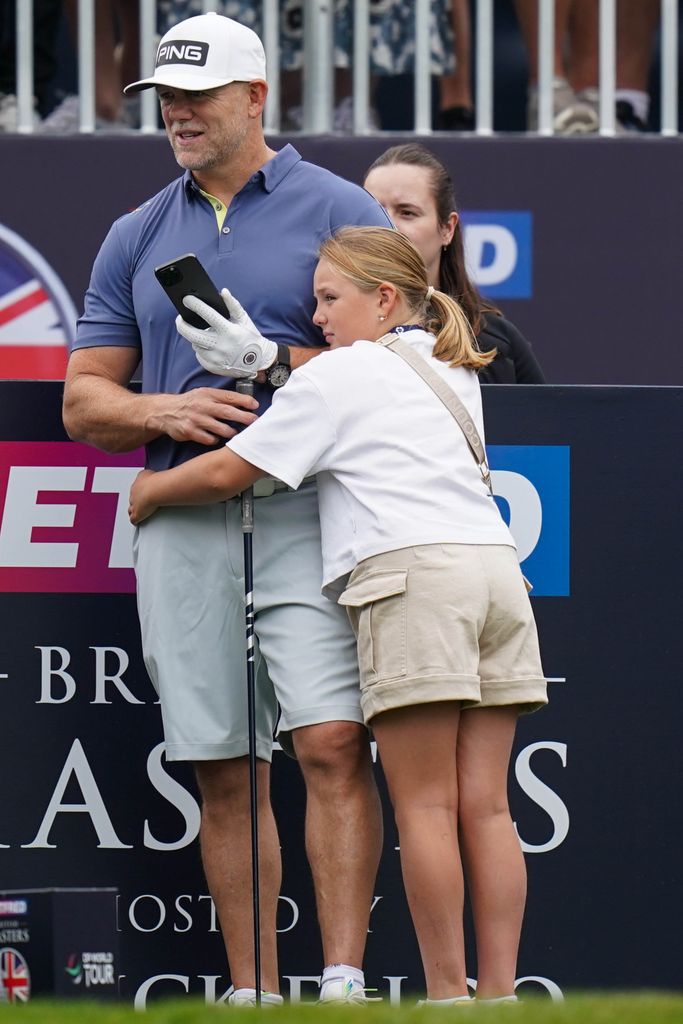 Mike Tindall and Mia sharing a hug at a gold tournament