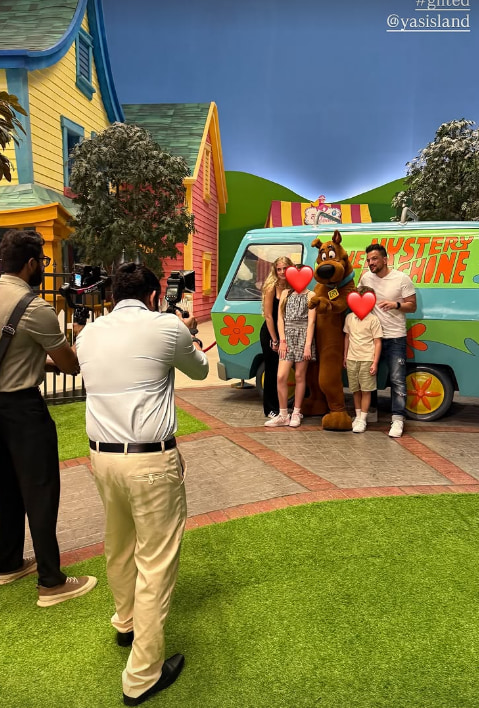 peter andre takes take photos at theme park in front of scooby doo bus