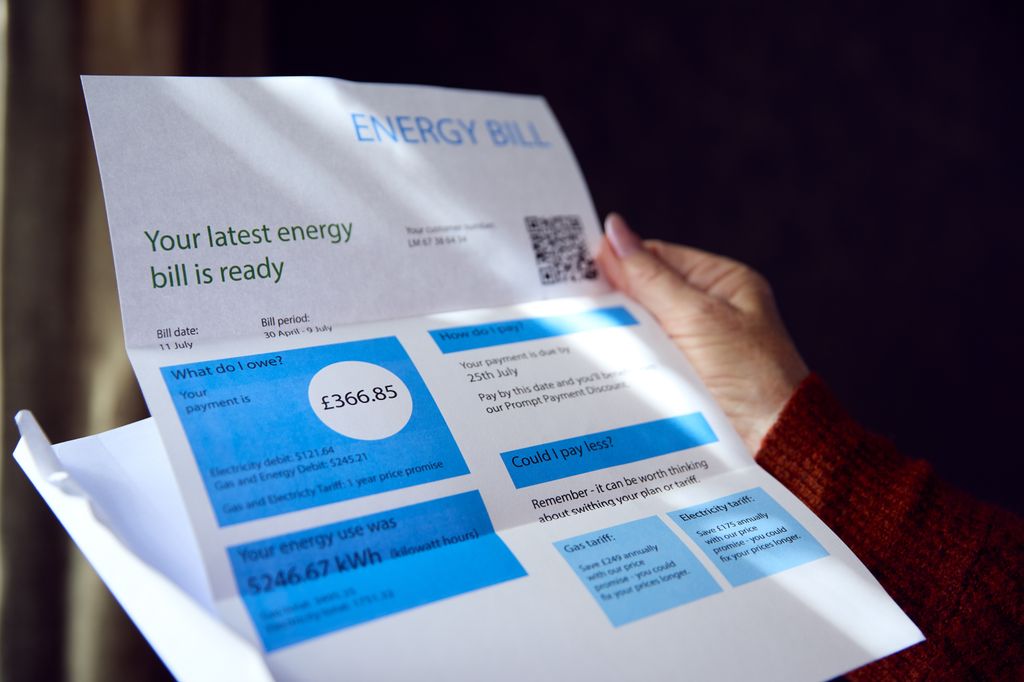 Woman opening expensive UK energy bill amid cost of living crisis 