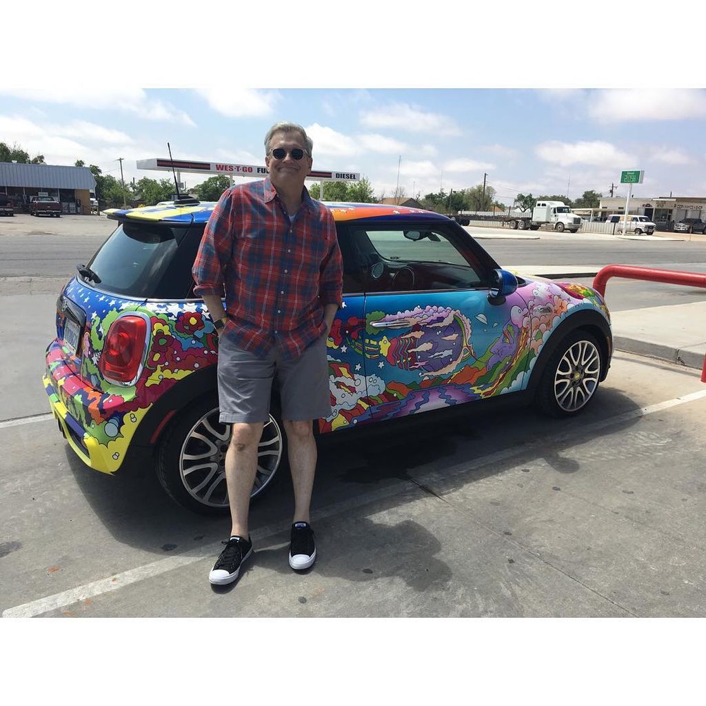 drew carey standing in front of custom painted mini cooper