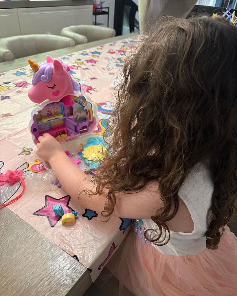 Patricia Lampard playing with toy unicorn 