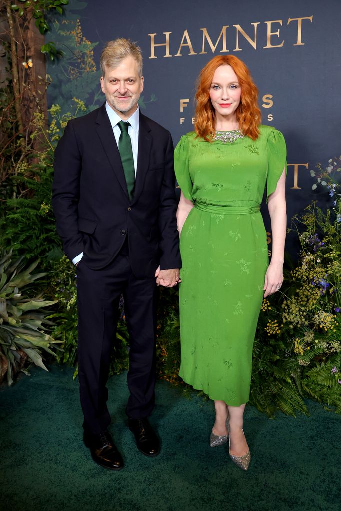 photo of christina hendricks in green dress holding hands husband george bianchini red carpet