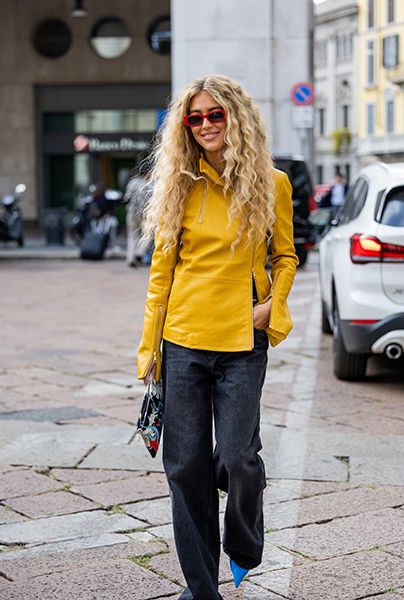 Woman Wearing Dark Denim Jeans With Asymmetric Jacket