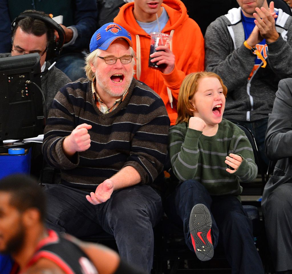 Philip Seymour Hoffman and Cooper Alexander Hoffman attend the Portland Trail Blazers vs New York Knicks game at Madison Square Garden on January 1, 2013 in New York City