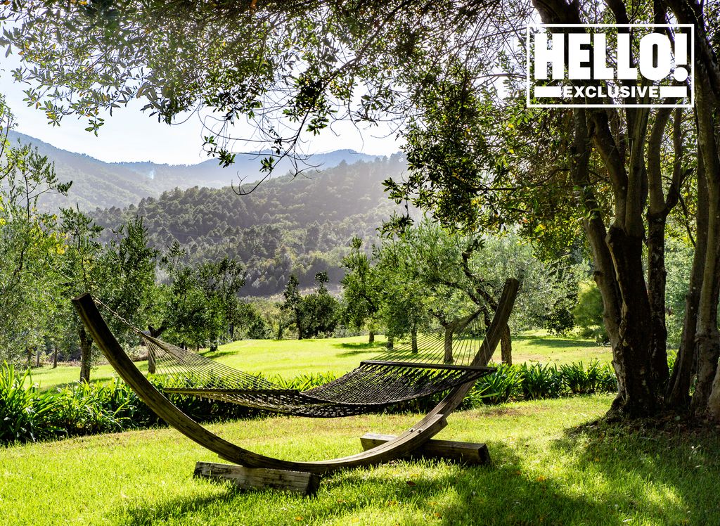 Suzanne Syz garden in Tuscany home with tree shaded hammock