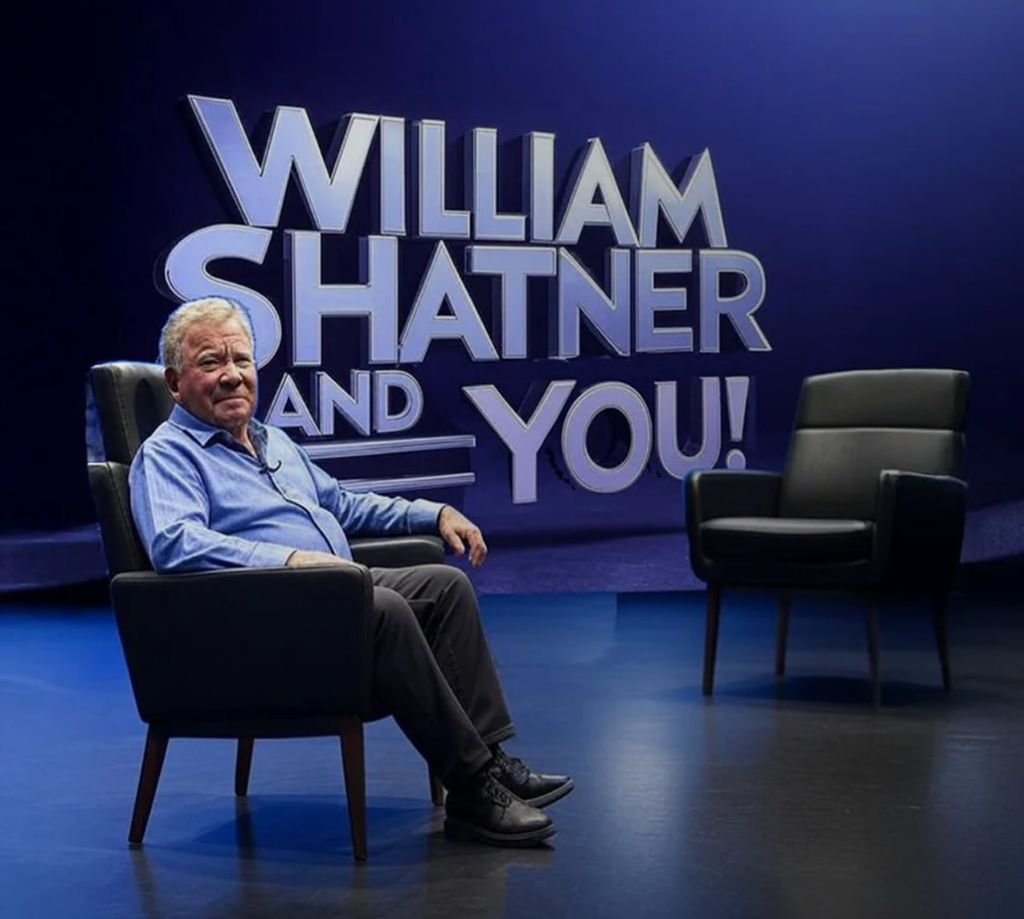 william shatner sitting in chair in front of book name william shatner and you