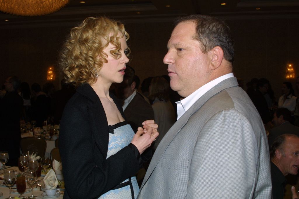 Nicole Kidman and Miramax CEO Harvey Weinstein mingle during the AFI Awards 2002 on January 16, 2003 in Los Angeles, California.
