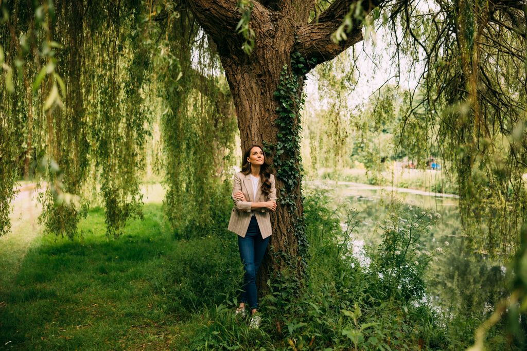 Kate Middleton standing next to tree