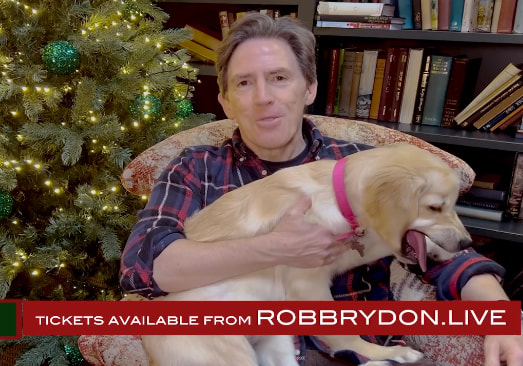 rob brydon with dog on his lap at home