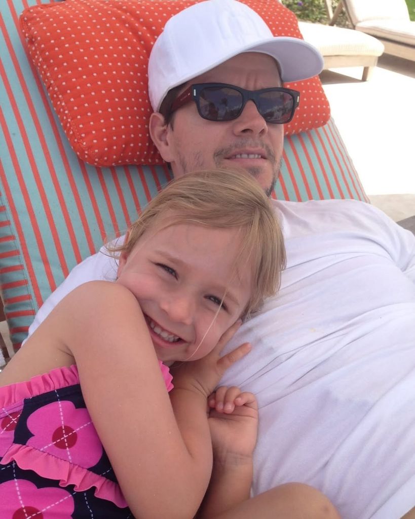 Grace Wahlberg lies on her father Mark Wahlberg on a beach chair, shared on Instagram