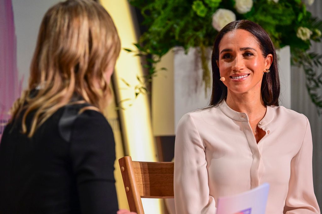 The Duchess of Sussex looked business chic in a blouse and skirt on Oct. 14