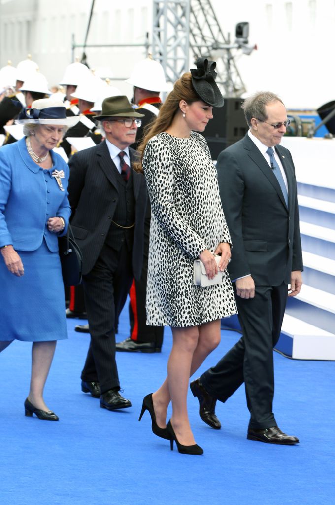 Catherine in dalmatian print dress walking among people