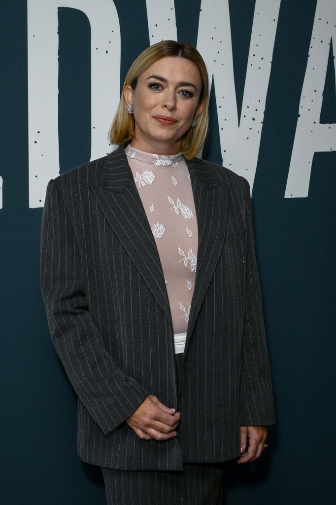 Eve Myles attends the "Coldwater" Photocall on September 03, 2025 in London, England, wearing a pinstripe blazer and a sheer top